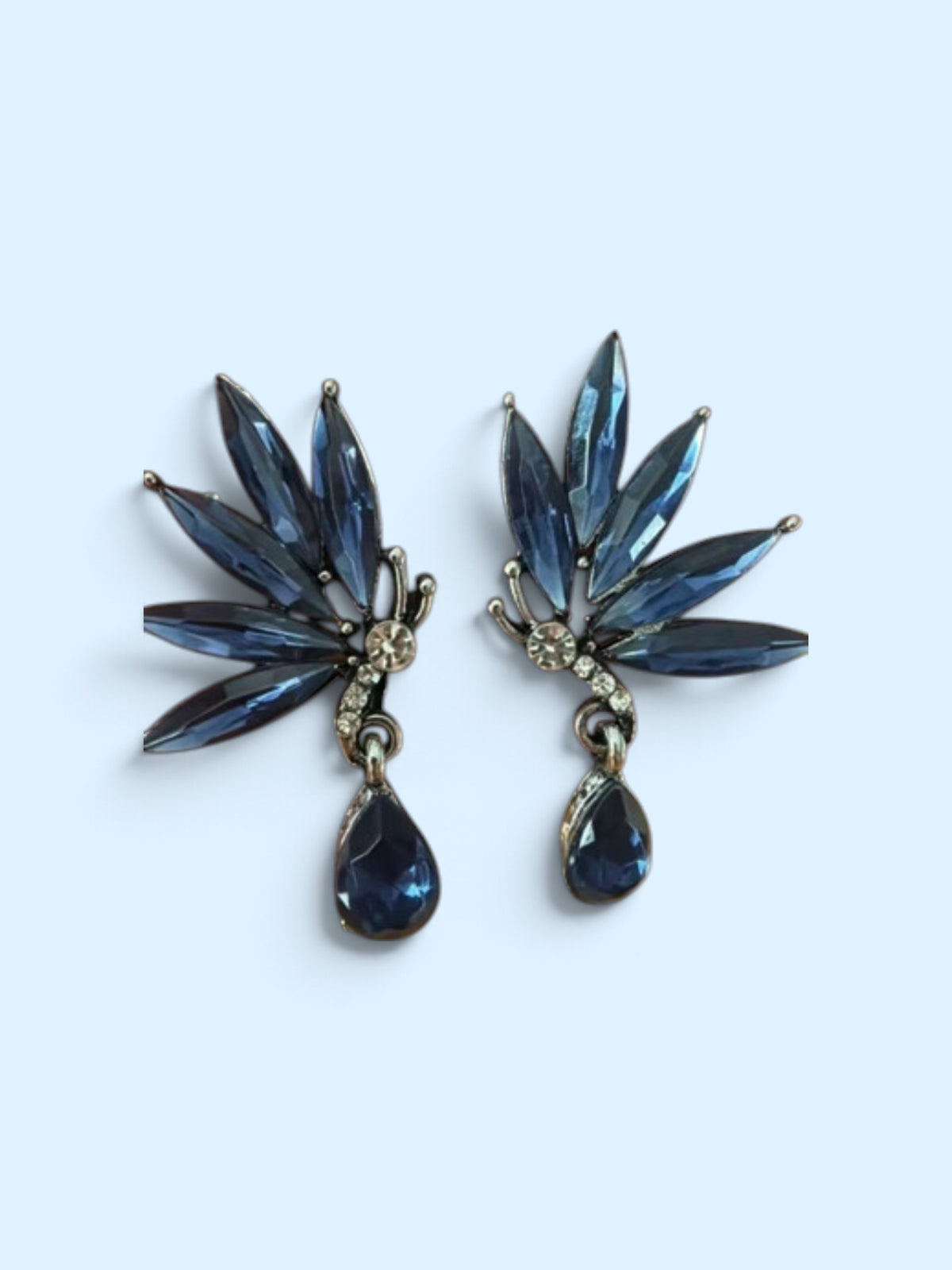Calilo Australia butterfly-inspired drop earrings with midnight-blue marquise crystals and clear pavé accents.