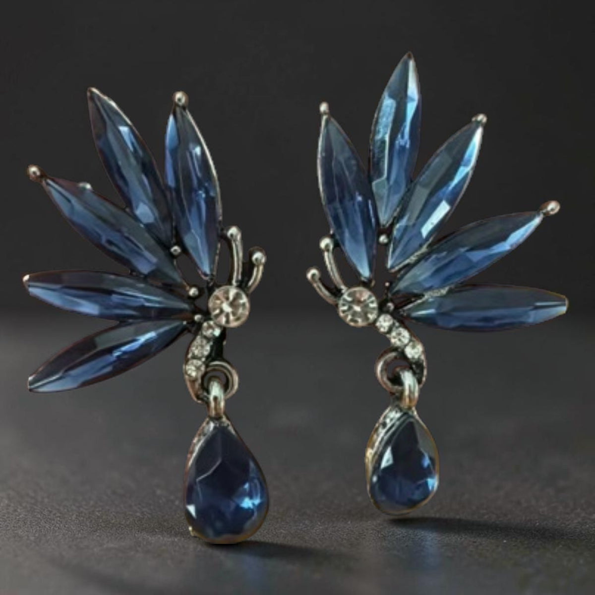 Calilo Australia butterfly drop earrings with midnight-blue marquise crystals, clear pavé accents, and silver setting.