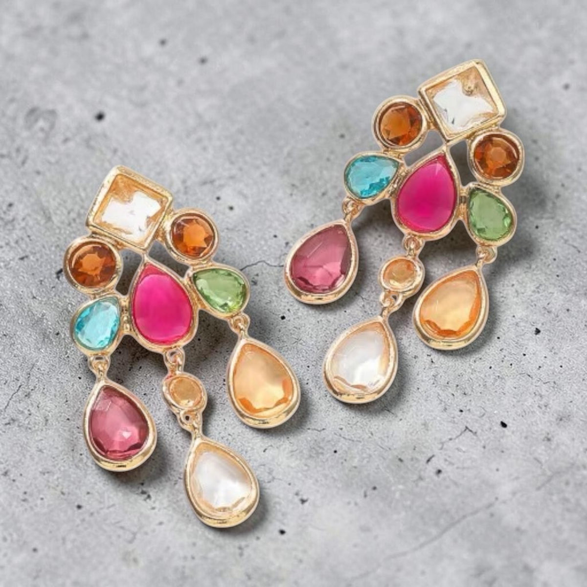 Calilo Australia Estelle chandelier earrings featuring gold-tone metal and multi-colored faceted teardrop crystals.