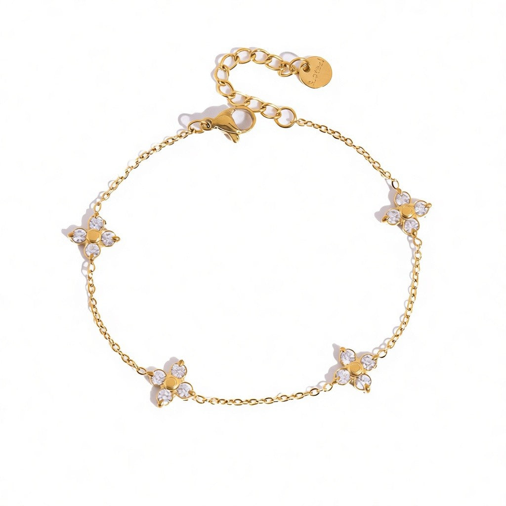 Calilo Australia gold chain bracelet featuring four delicate floral charms with sparkling cubic zirconia stones.