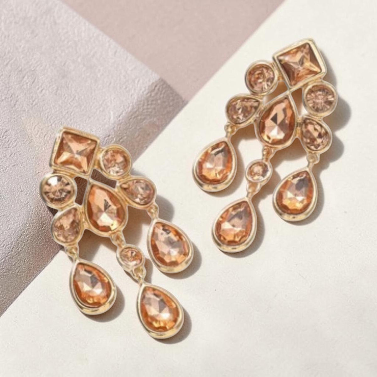 Calilo Australia gold-tone chandelier earrings with cascading teardrop-shaped champagne crystals for evening wear.
