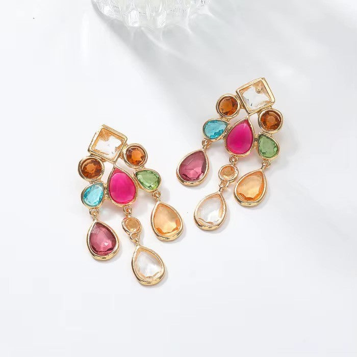 Calilo Australia statement chandelier earrings featuring gold-tone metal and multi-colored faceted teardrop crystals.