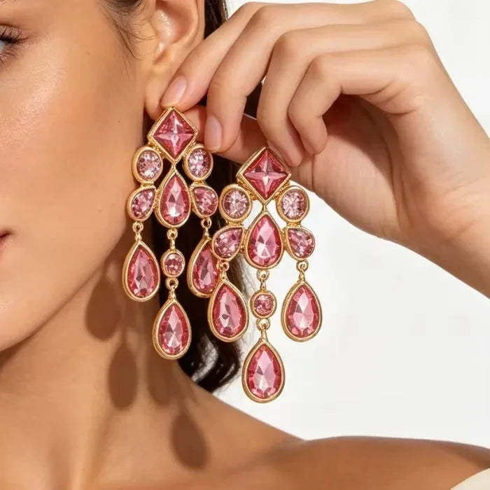 Calilo Australia statement chandelier earrings featuring pink crystals in a polished gold-tone geometric drop design