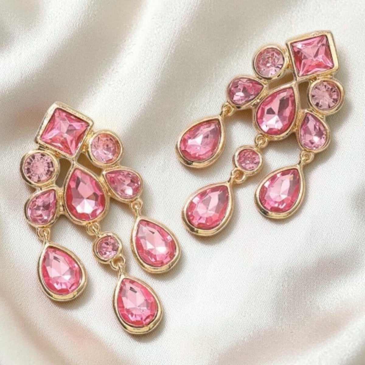 Calilo Australia chandelier drop earrings featuring pink crystals in a polished gold-tone geometric setting.
