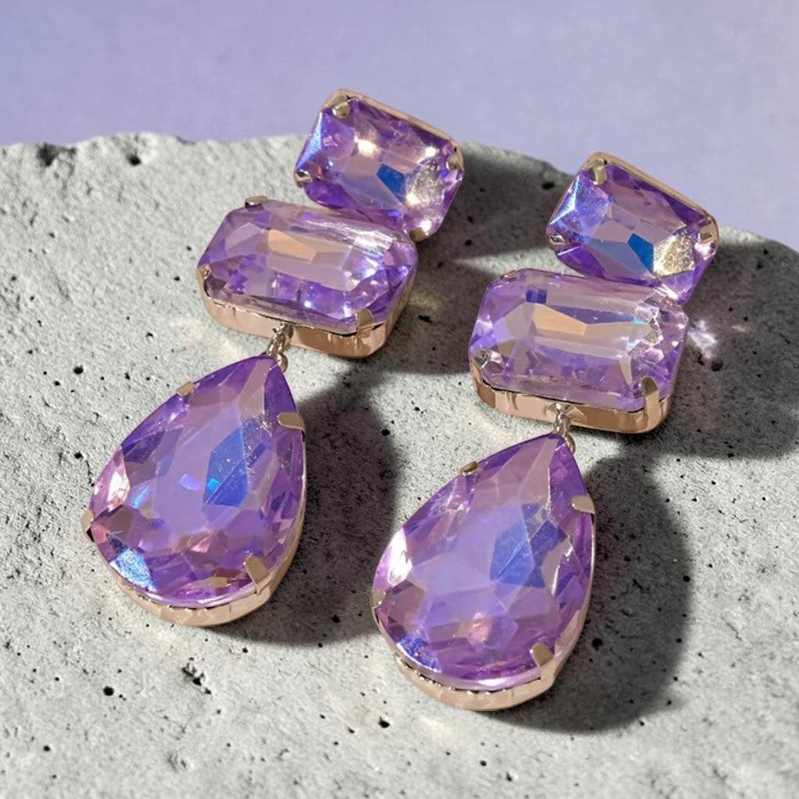 Calilo Australia elegant drop earrings featuring iridescent purple rectangular and pear-shaped crystals in gold settings.