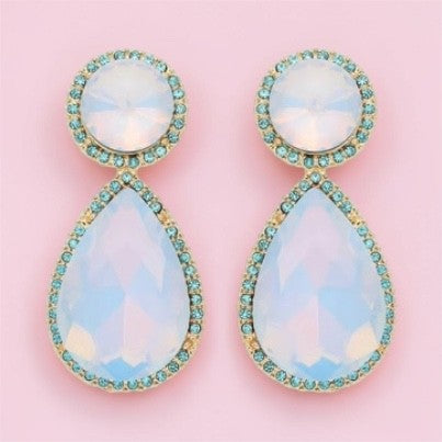 Calilo Australia gold-toned statement drop earrings with iridescent teardrop stones and blue crystal halo accents.