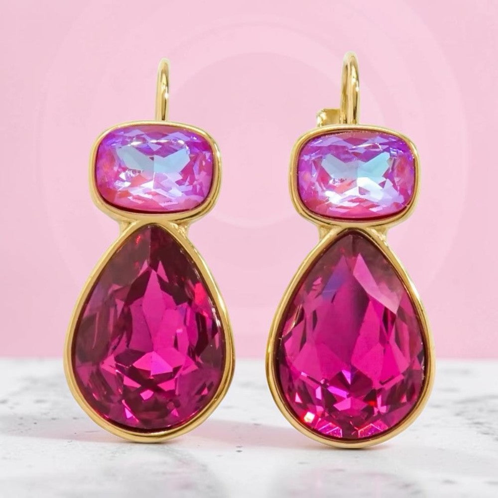 Calilo Australia dual-tone teardrop crystal earrings featuring iridescent pink and fuchsia stones in gold-tone frames.